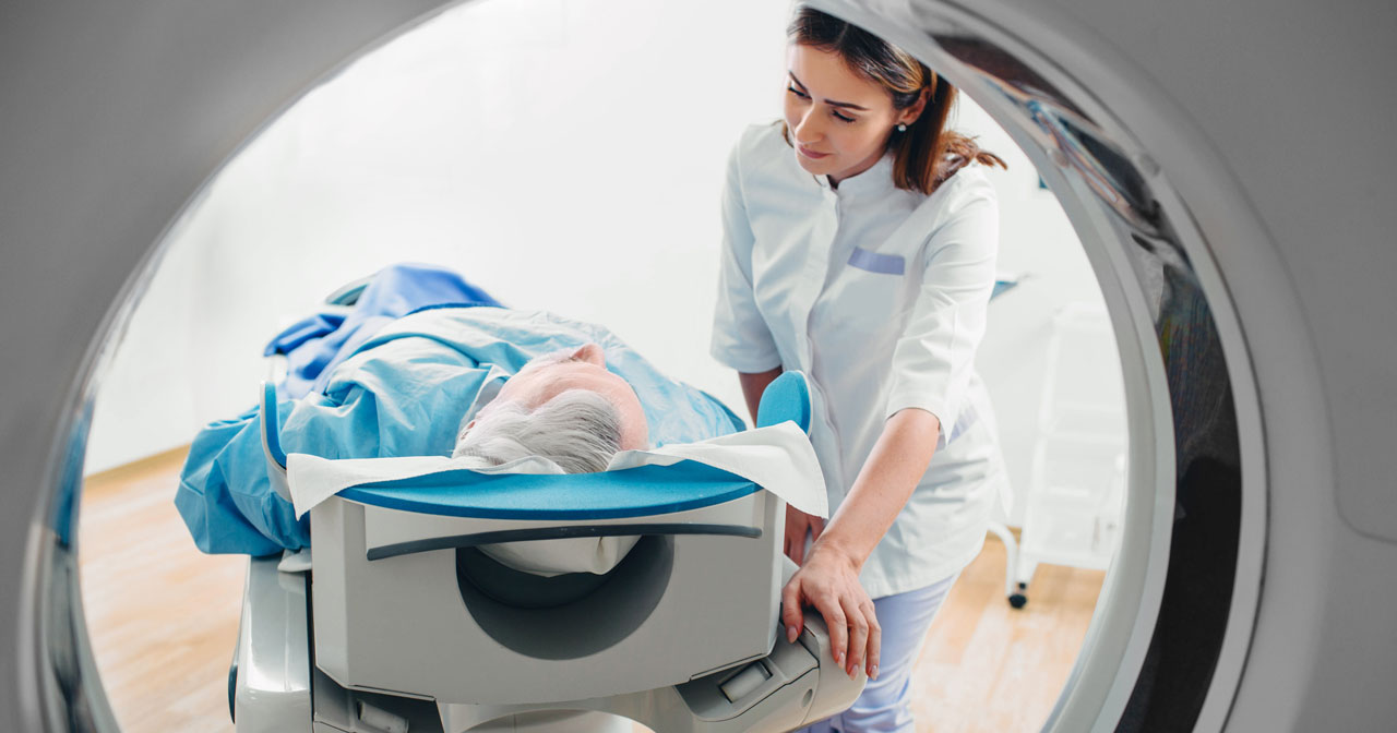 Technologist speaks with patient having imaging study