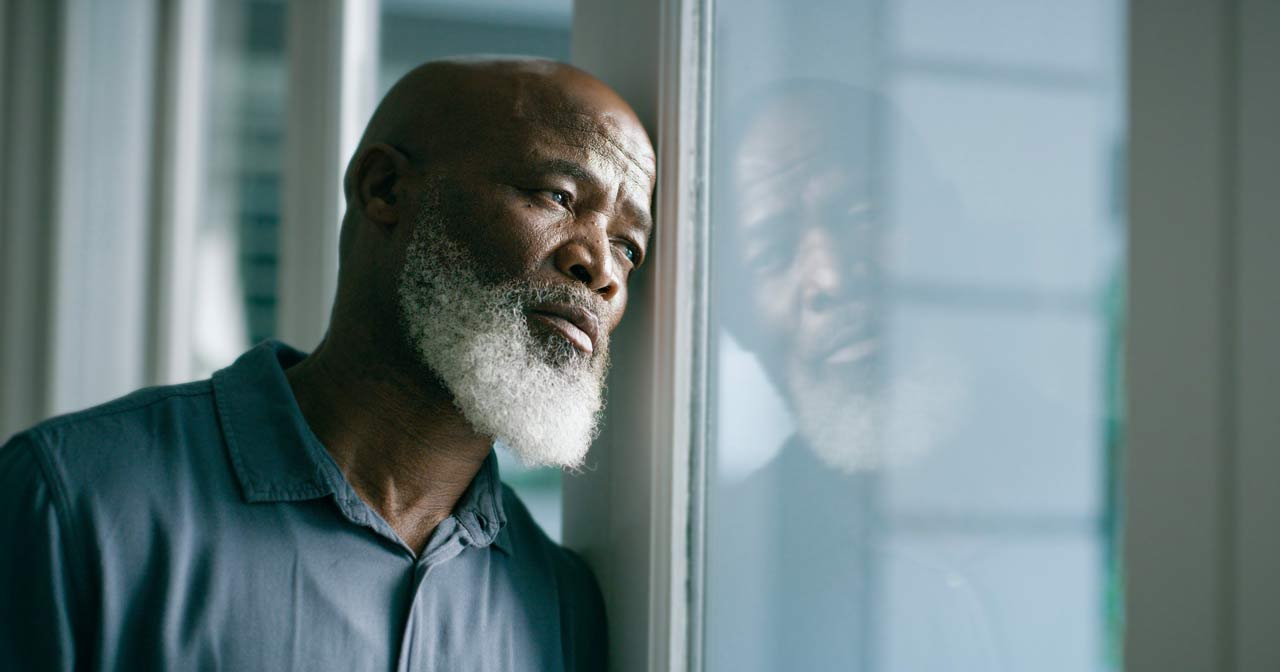 Photo of man staring out the window