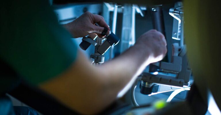 Photo of a surgeon's hands as they work. with the robotic surgical system